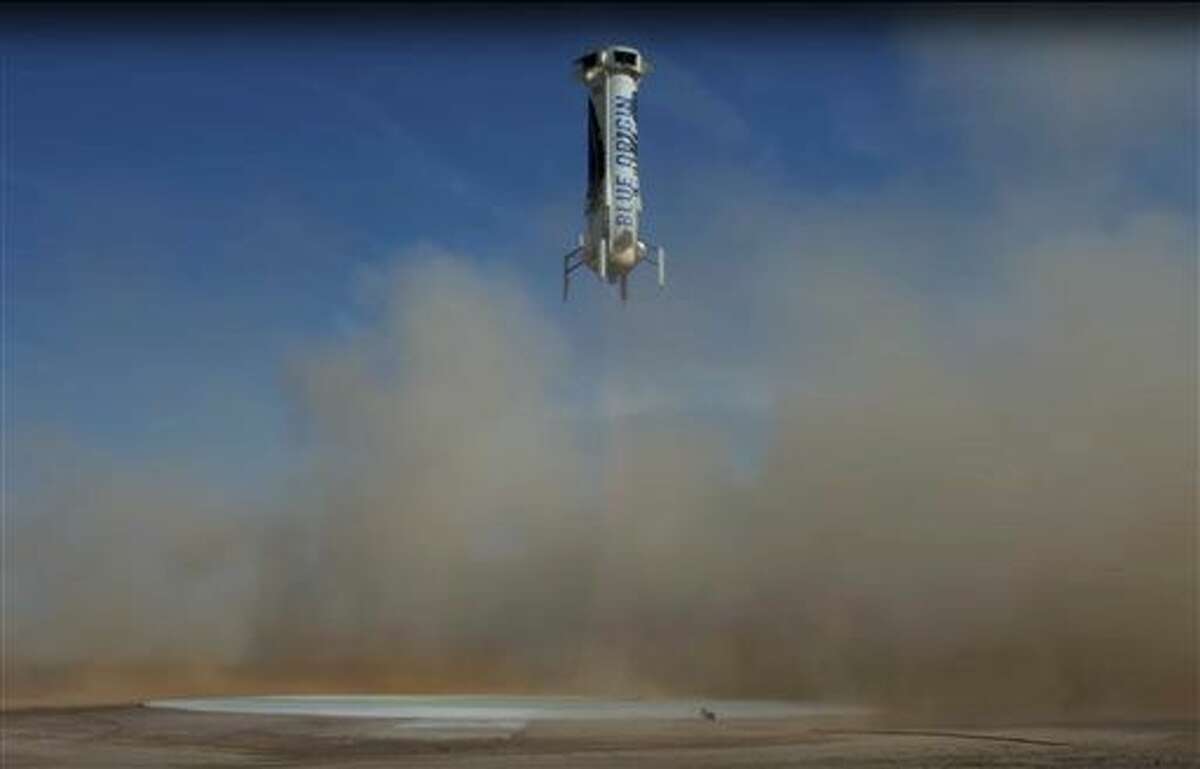 In this photo made from video provided by Blue Origin, New Shepard, an unmanned rocket, prepares to land in an area near Van Horn, Texas, Sunday, June 19, 2016. The private space company run by Amazon CEO Jeff Bezos has completed its fourth successful unmanned rocket launch and safe landing in West Texas using the same vehicle. (Blue Origin via AP) MANDATORY CREDIT