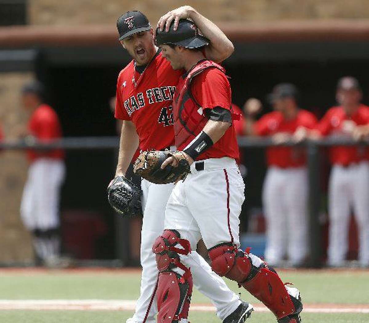 Texas Tech's Chris Sadberry (42) celebrates with Hunter Redman, right, after an out against College of Charleston during an NCAA college baseball tournament super regional game in Lubbock, Texas, Saturday, June 7, 2014. Texas Tech won 1-0. (AP Photo/Lubbock Avalanche Journal, Shannon Wilson)