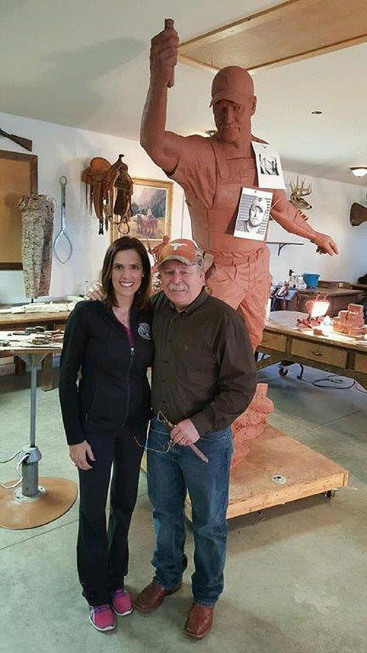 Taya Kyle, widow of Chris Kyle, poses with sculptor Vic Payne, who created the 15-foot statue that will be part of the memorial to the former Navy SEAL.