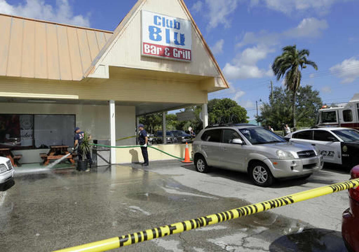 Fort Myers fire fighters hose down the pavement at the scene of a deadly shooting outside the Club Blu nightclub in Fort Myers, Fla., Monday, July 25, 2016. Police said the gunfire, which erupted at a swimsuit-themed party for teens, was not an act of terrorism. (AP Photo/Lynne Sladky)