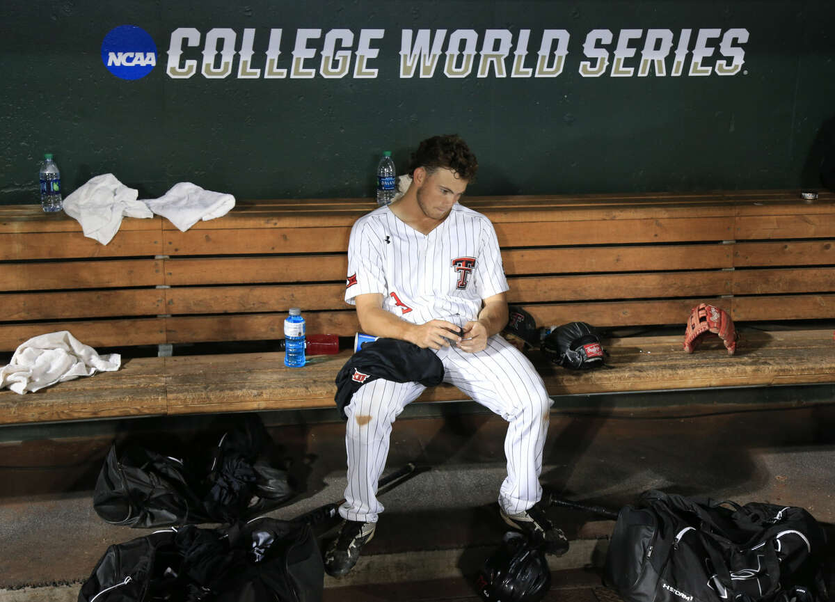 Texas Tech's Michael Davis sits in the dugout after losing to Coastal Carolina 7-5 in an NCAA College World Series baseball game in Omaha, Neb., Friday, June 24, 2016. (AP Photo/Nati Harnik)