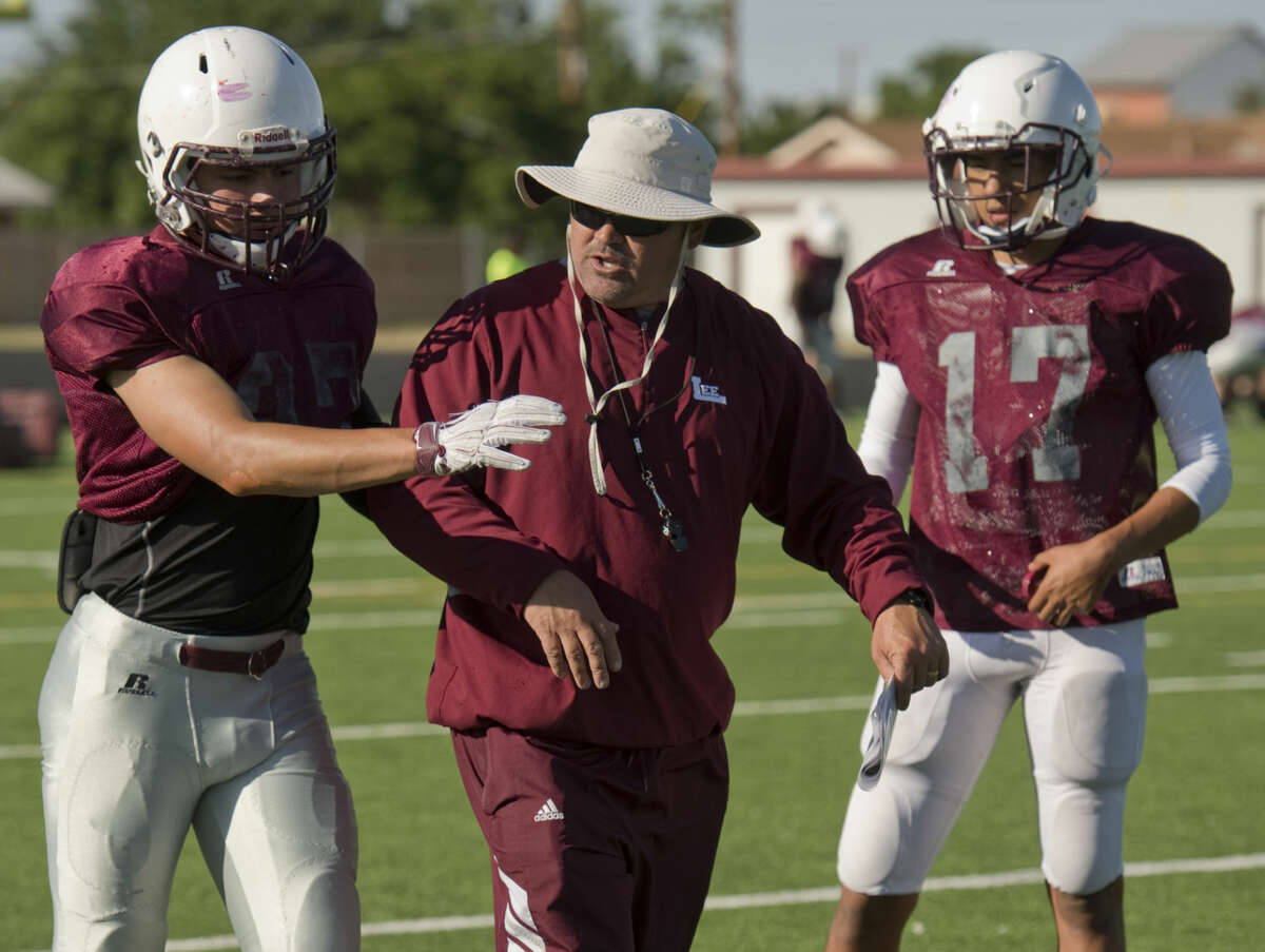 New Lee High coach Clint Hartman works with his players as they run drills Monday 05-02-16, during the first day of Spring practice Tim Fischer\Reporter-Telegram