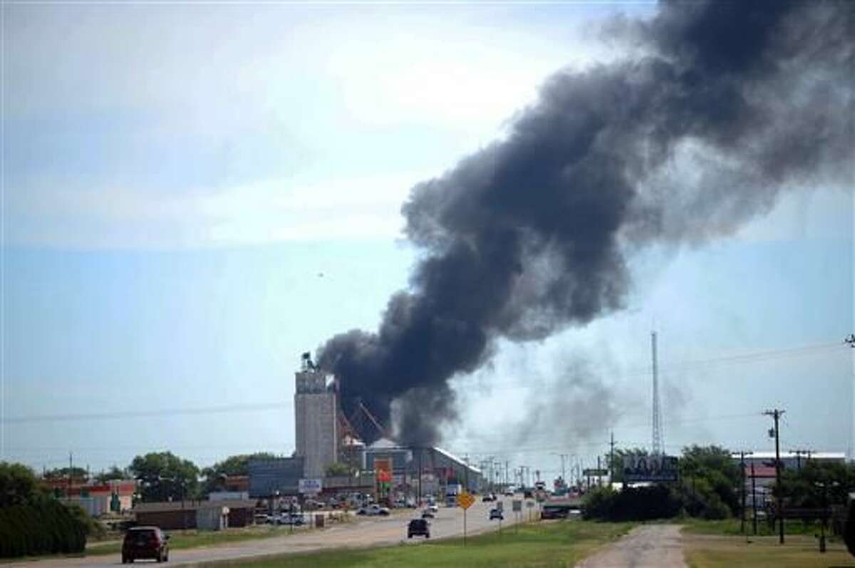 Three crew members were missing and one was hurt Tuesday, June 28, 2016, after a head-on train collision in Panhandle, Texas, that caused several box cars to erupt in flames and led authorities to evacuate residents in the area. The fire was still burning several hours later. An NTSB team has been dispatched to the scene. (Sean Steffen/Amarillo Globe-News via AP)