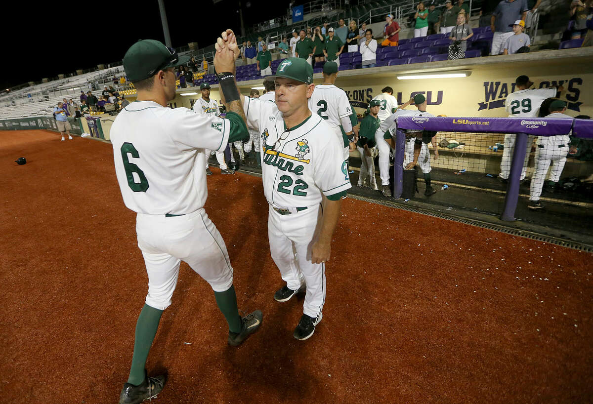 In this May 31, 2015 photo, Tulane coach David Pierce (22) thanks his players after the elimination game between Tulane and UNC-Wilmington at the Baton Rouge Regional in Baton Rouge, La. Texas reached an agreement Wednesday, June 29, 2016, with Tulane baseball coach David Pierce to take over the Longhorns' program, a person with knowledge of the decision said. (Michael DeMocker/NOLA.com The Times-Picayune via AP)