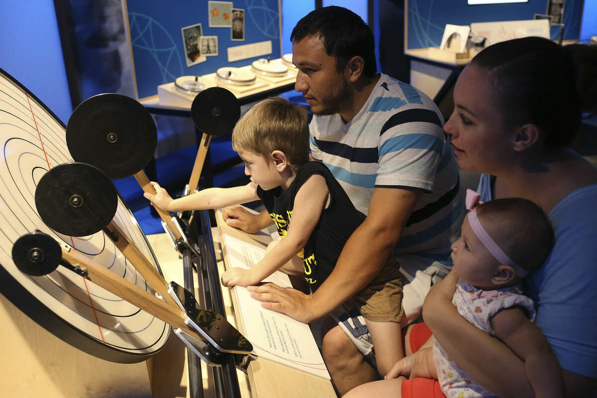 Liam Reyes, 3, plays with a game that explores frequencies at the Mathletics exhibit at the DoSeum, Sunday, August 28, 2016. The exhibit lets the public explore fundamental math concepts. With Reyes are from left, his father, Luis Reyes, 27, mother, Rebeka Reyes, 24 and sister, Spencer, 5-month-old. The family was on vacation from San Angelo.