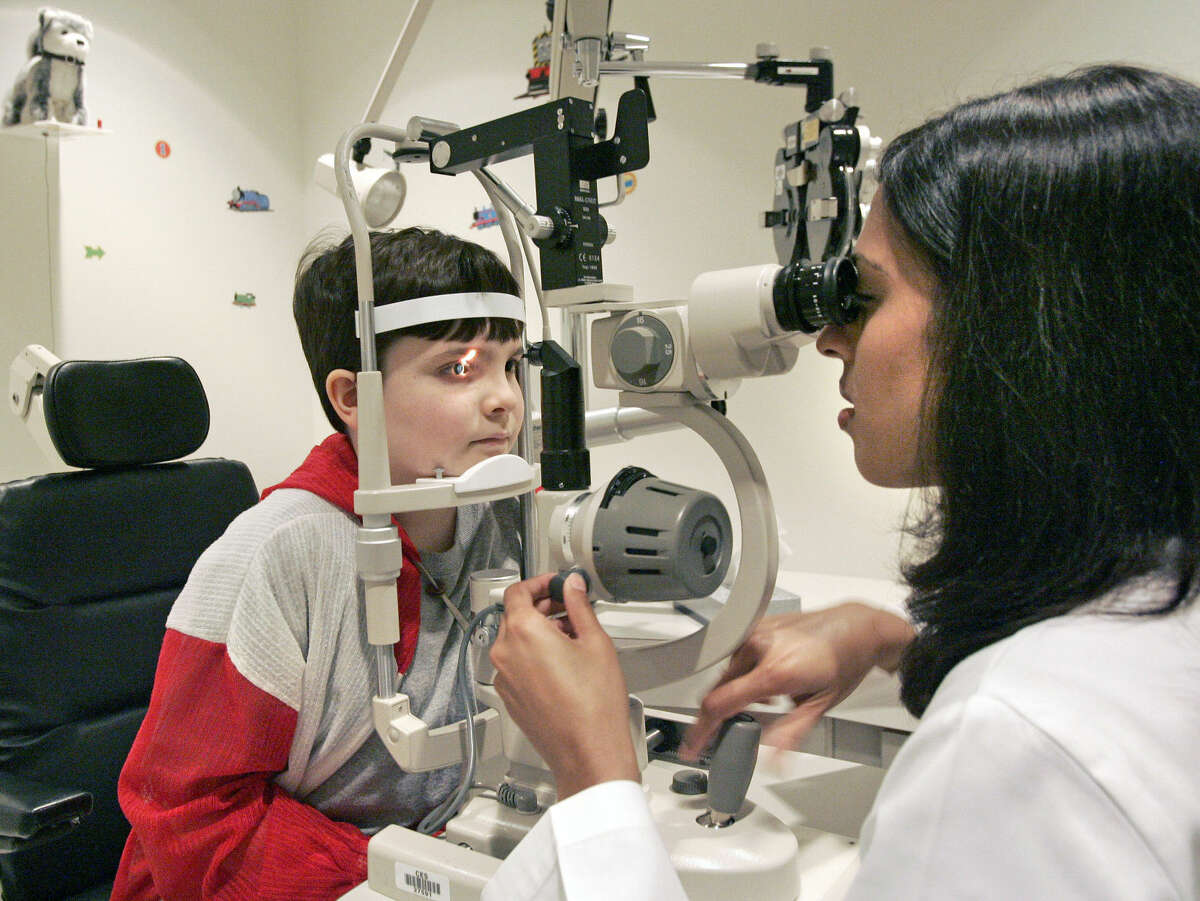 Health tab story on kids and eye exams. Here, 10-year-old Benjamin Musick of Tomball gets his eyes examined by Dr. Madhuri G. Chilakapati at the Kelsey-Seybold clinic, 2727 West Holcombe Blvd. If reporter needs it, Musick's mom is named Lisa Musick, PH: 281-516-9198. Friday 06/29/07. (Craig H. Hartley/For the Chronicle)