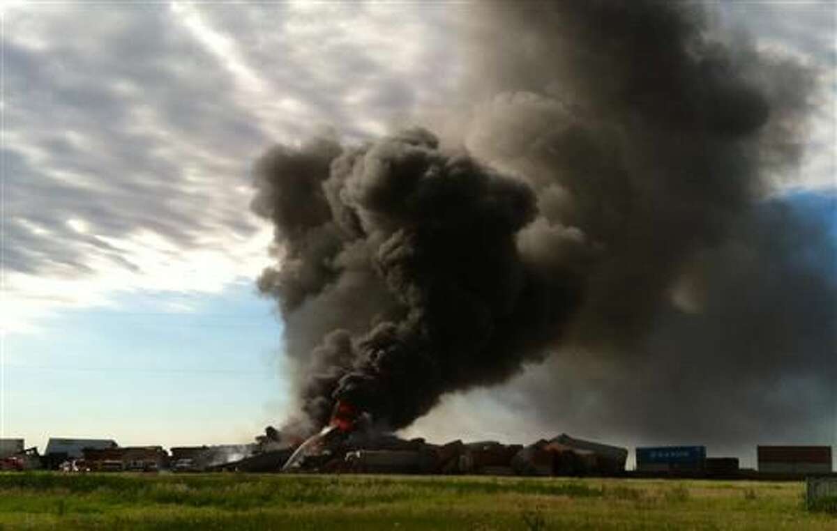 In this photo provided by Billy B. Brown, two freight trains are on fire Tuesday, June 28, 2016, after they collided and derailed near Panhandle, Texas. Texas Department of Public Safety Lt. Bryan Witt says the accident occurred Tuesday morning near the town of Panhandle, about 25 miles northeast of Amarillo. No injuries have been reported. (Billy B. Brown via AP)