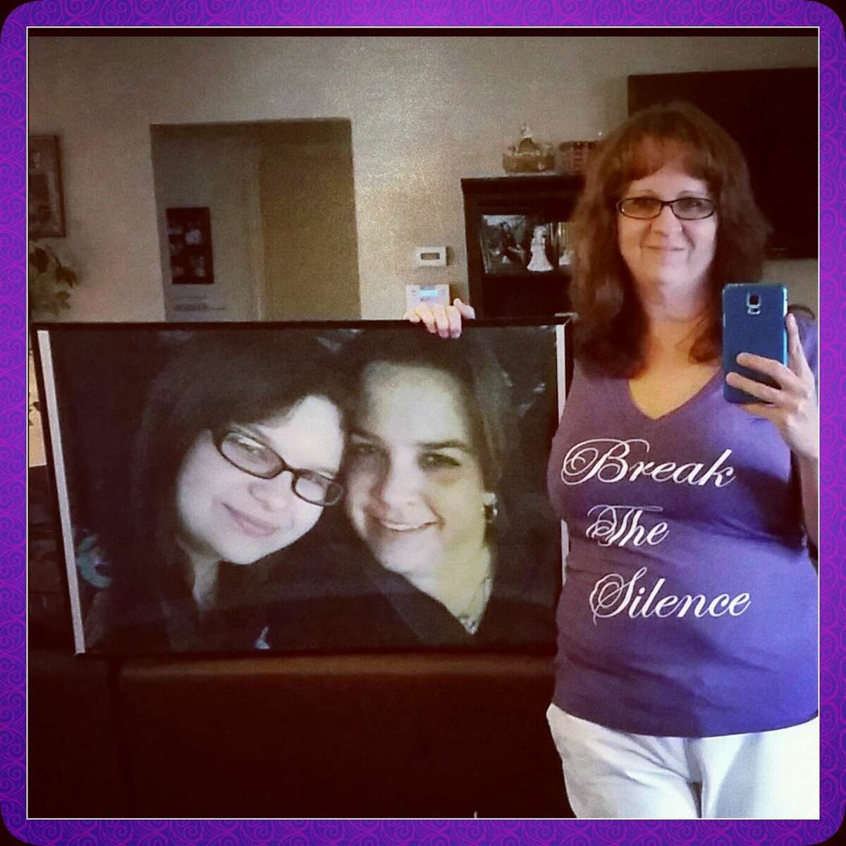 Laura Dimery holds a picture of her sister Jennifer Krieger and niece Kelsie who were both murdered by Krieger's fiance in 2013.