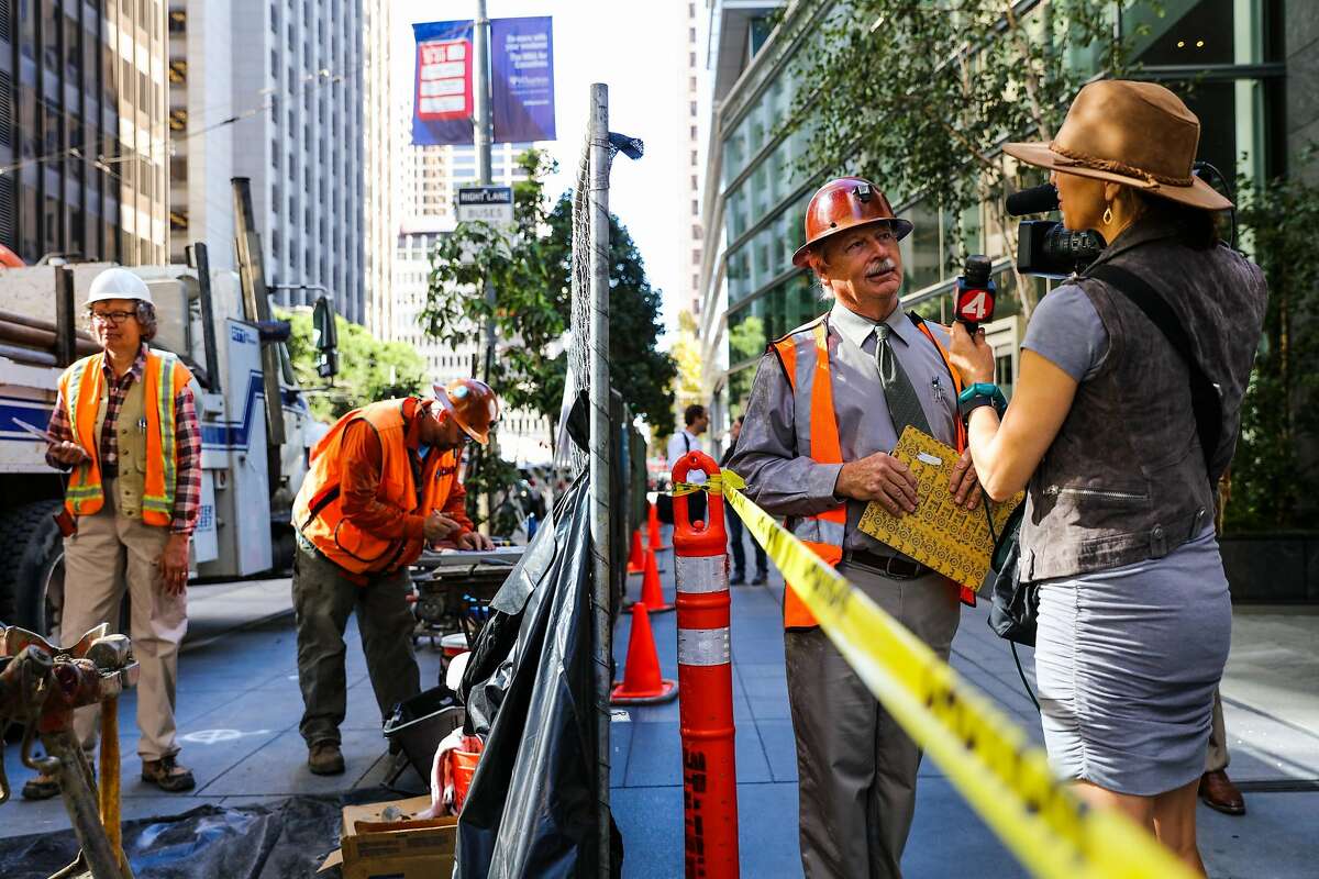 Engineer and consultant Patrick Shires (second from right), of Cotton Shires and Associates, gives an interview regarding the investigation of Millennium Tower, a residential building which is leaning, in San Francisco, California, on Monday, Sept. 26, 2016.