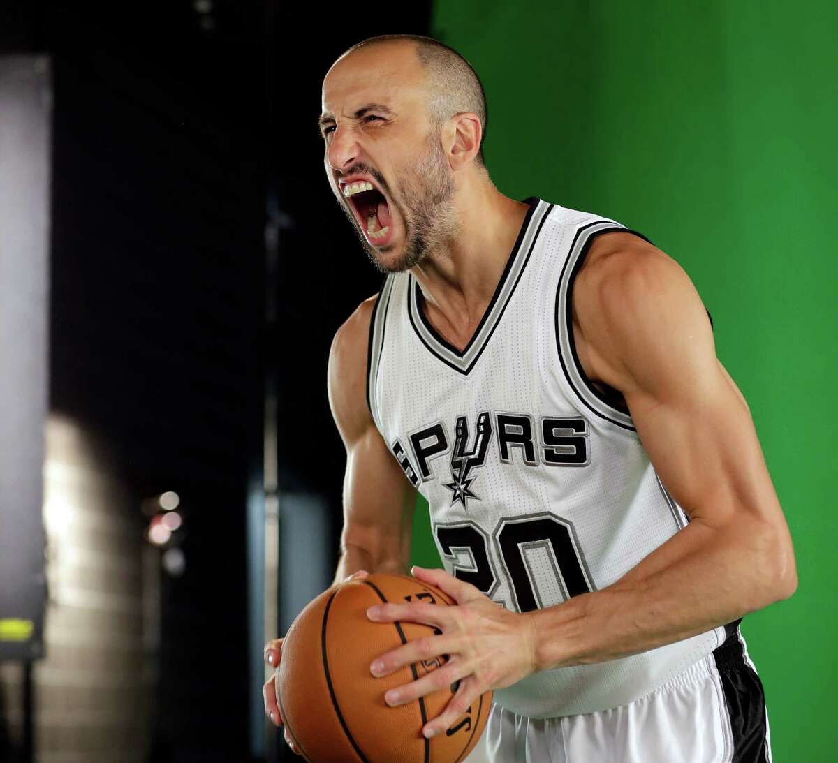 Spurs guard Manu Ginobili poses for photos during media day on Sept. 26, 2016, in San Antonio.