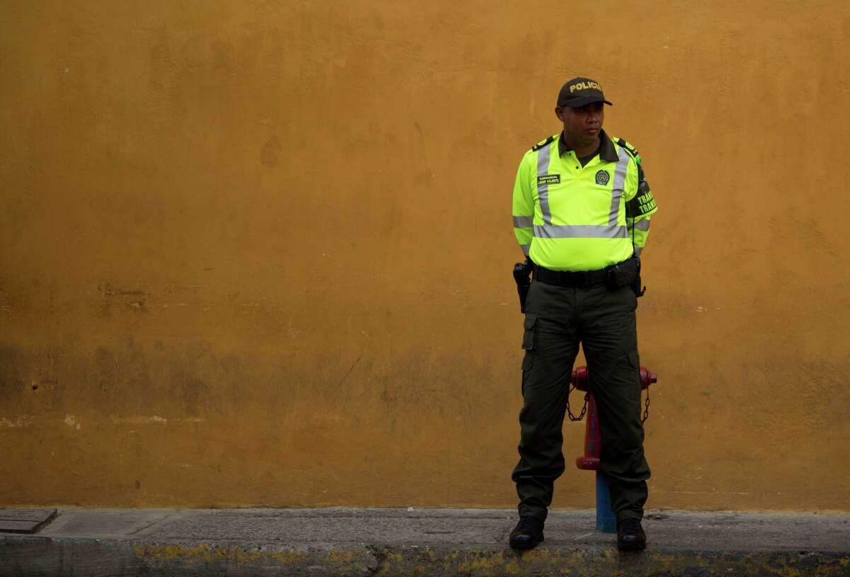 A traffic policeman stand on a street in Cartagena, Colombia, Sunday, Sept. 25, 2016. Colombia's government and the Revolutionary Armed Forces of Colombia, FARC, will sign a peace agreement to end over 50 years of conflict, in Cartagena, on Monday. (AP Photo/Ariana Cubillos)