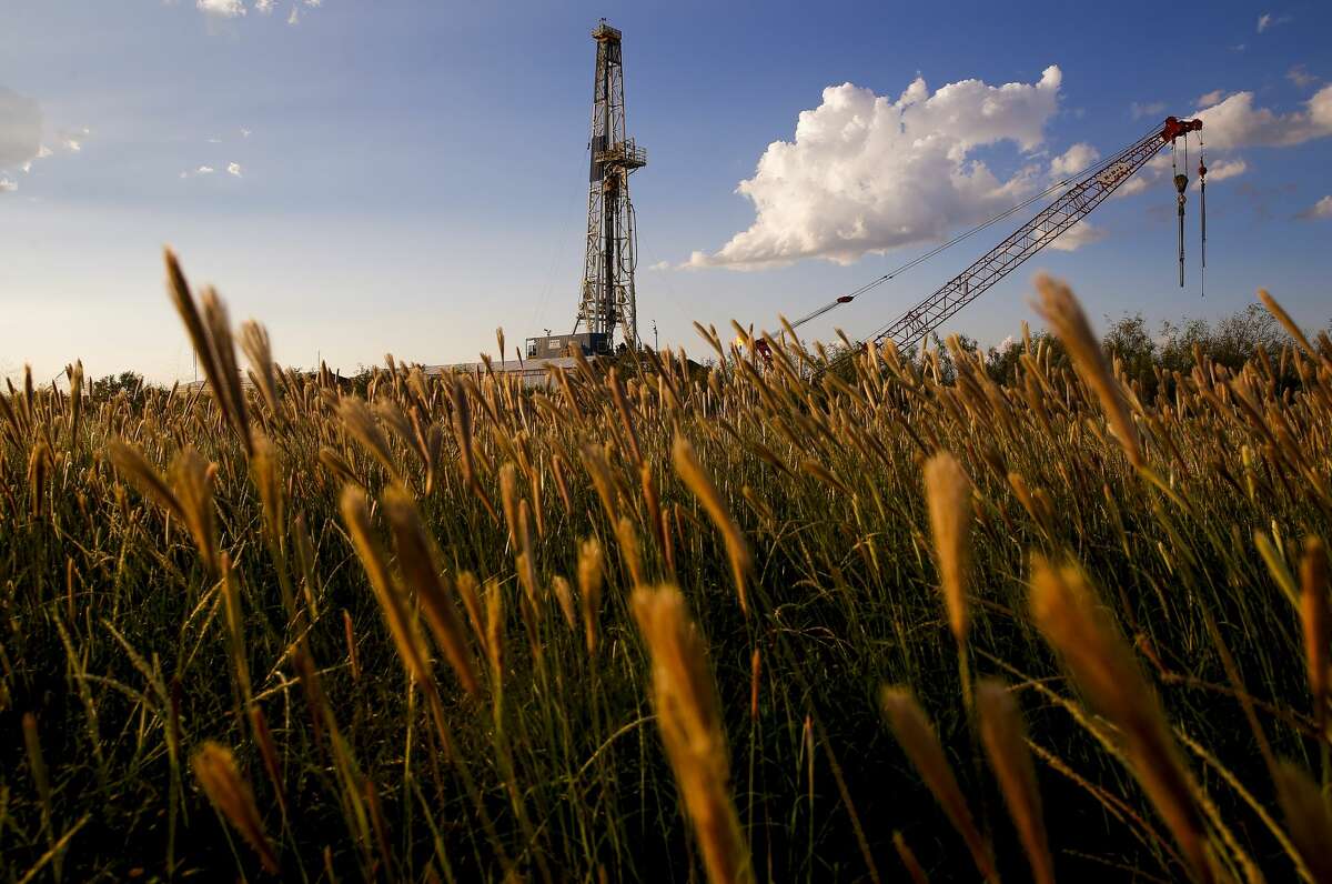 An Apache Corporation drilling rig sits north of the Davis Mountains Friday, Sept. 16, 2016 in Balmorhea. The company recently announced the discovery of an estimated 15 billion barrels of oil and gas in the area and plans to drill and use hydraulic fracturing on the 350,000 acres surrounding the town. Apache has leased the mineral rights under the town and nearby state park, but has promised not to drill on or under either. While some residents worry that the drilling could affect the spring at the state park and impact tourism, others are excited for the potential economic boom the oil discovery and drilling could bring. ( Michael Ciaglo / Houston Chronicle )