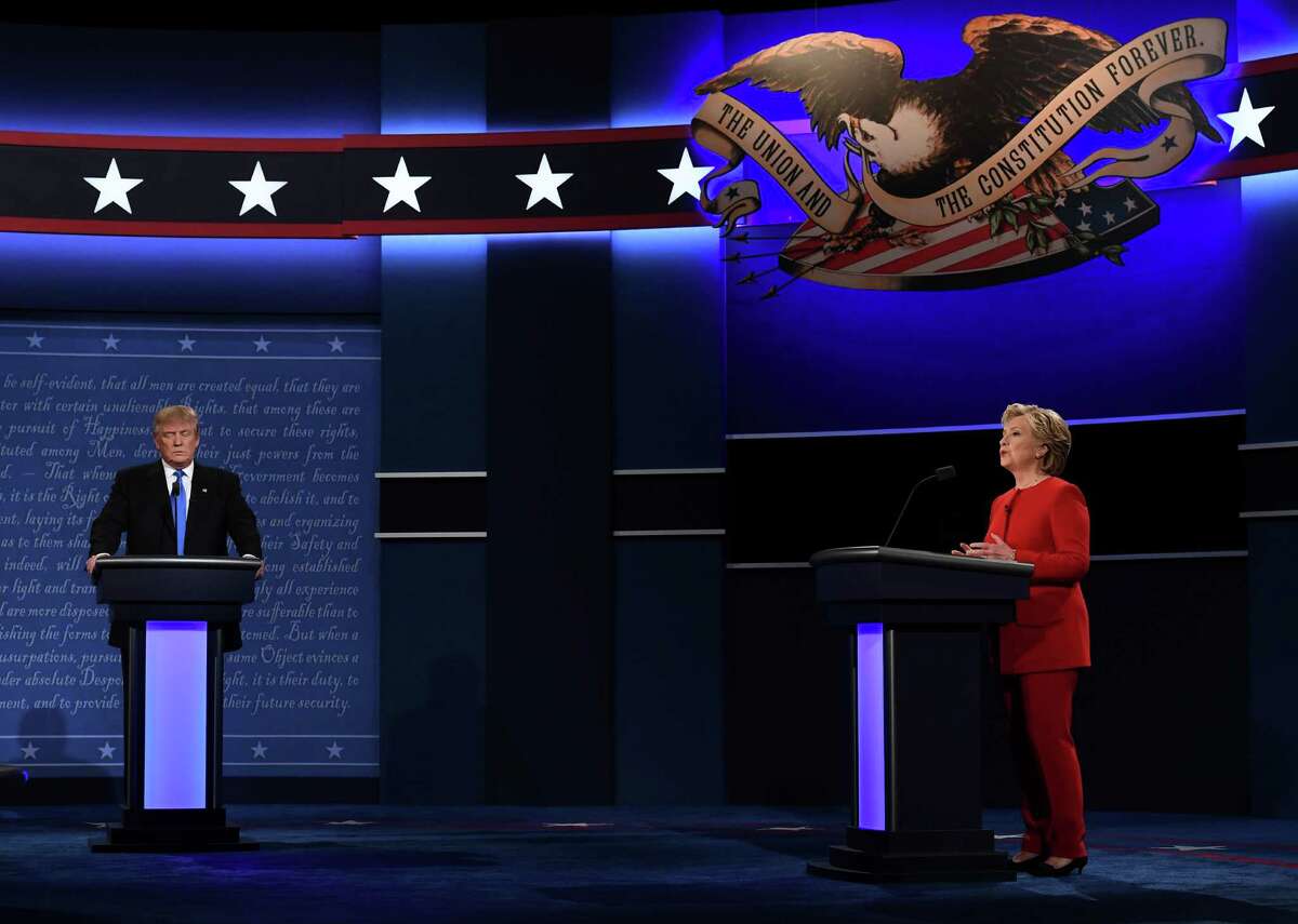 Republican nominee Donald Trump looks on as Democratic nominee Hillary Clinton speaks during the first presidential debate at Hofstra University in Hempstead, New York on September 26, 2016. / AFP PHOTO / Jewel SAMADJEWEL SAMAD/AFP/Getty Images