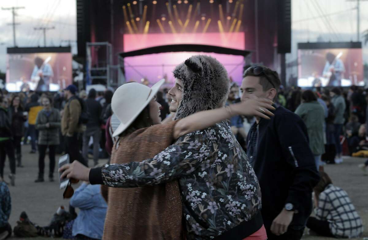 Josh Moscovitz, right, hugs friend Camille Bemer, left, during the Treasure Island Music Festival on Treasure Island, in San Francisco, Calif., on Sunday, October 18, 2015.