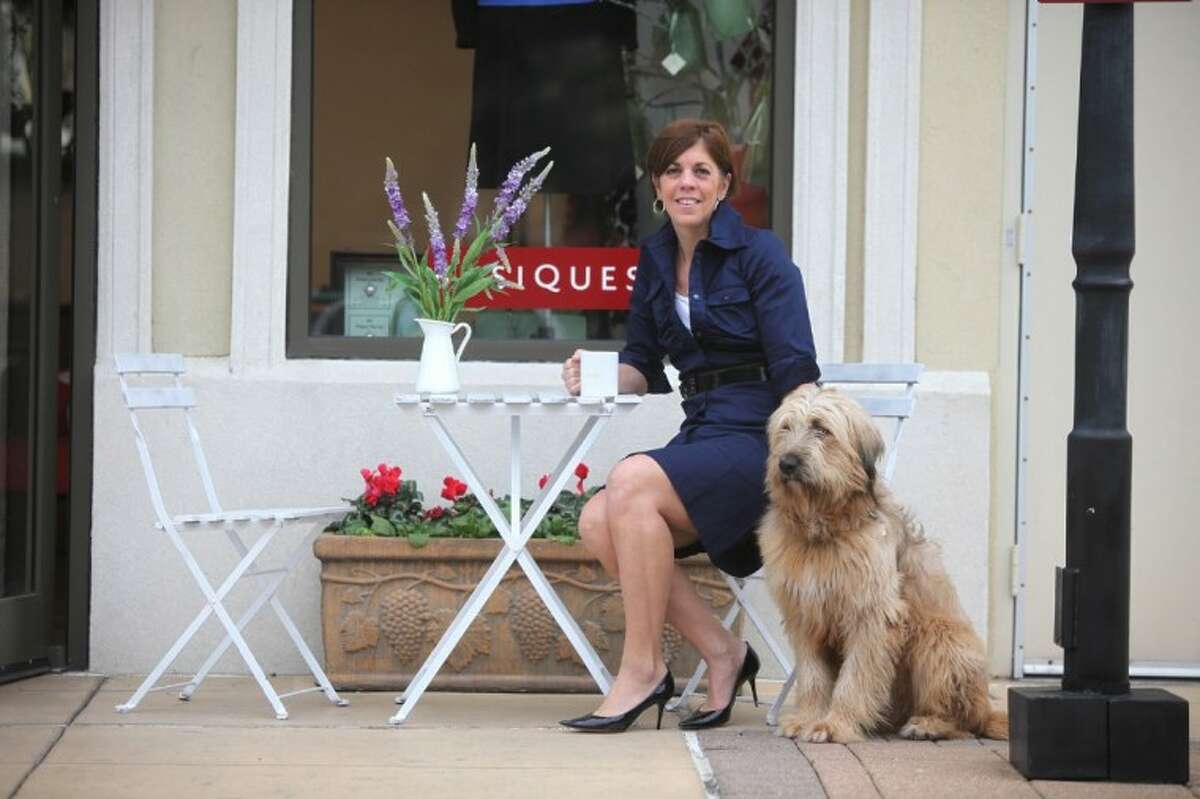 Sheri Falk and her dog, Tonto, at Basiques in Houston’s Uptown. After spending time in France, Falk develped the Basiques clothing line which offers a timeless collection based on the French commitment to quality, simplicity, and elegance. (Photo by Alan Warren)