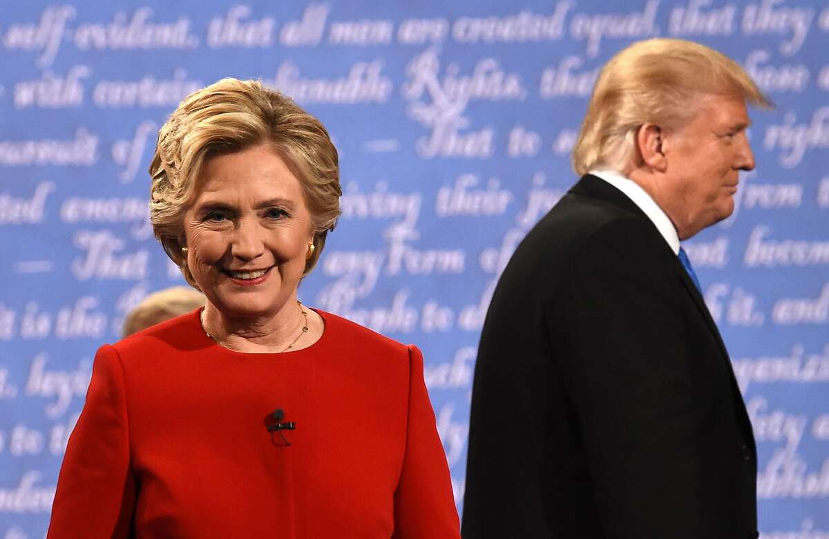Democratic nominee Hillary Clinton and Republican nominee Donald Trump leave the stage after the first presidential debate at Hofstra University in Hempstead, New York on September 26, 2016. 