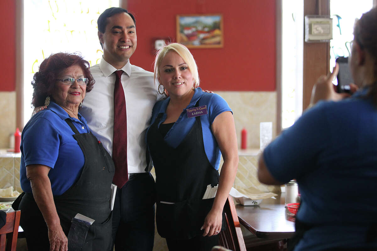 Malt House wait staff Gloria Ricondo, 70, left, and Maria Trevino, 28, (tilde over n), get their picture taken with U.S. Congressman Joaquin Castro, Tuesday, May 28, 2013.