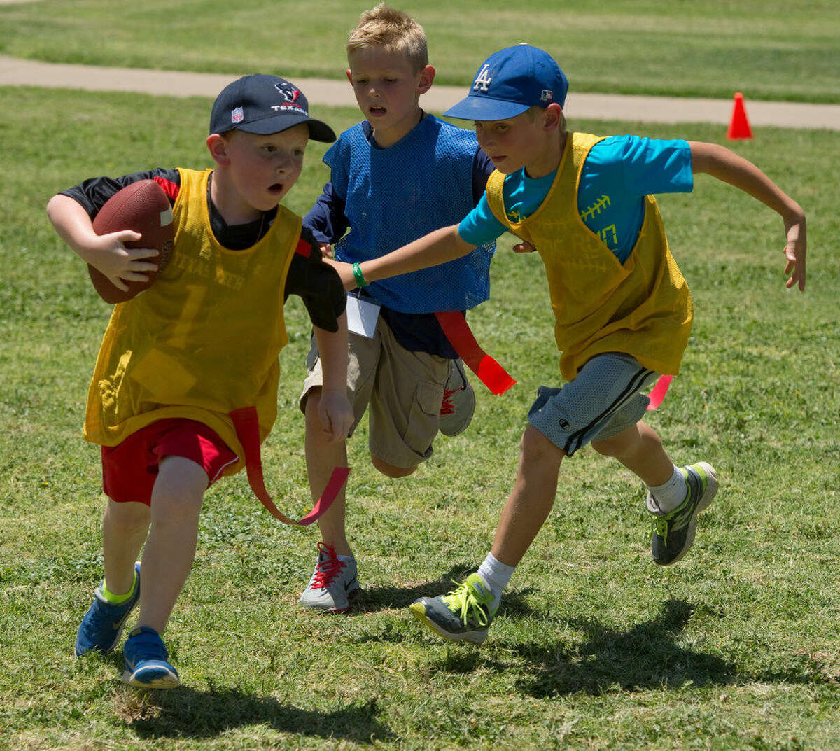 Boys play flag football at Midland College in June. A decrease in physical activity has led to an increase in the number of children who are overweight or obese.
