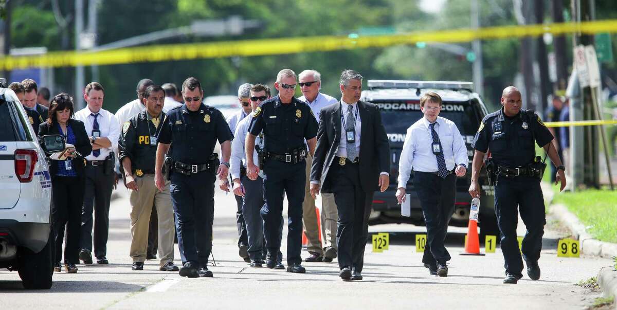 Officials investigate the scene where they say a local lawyer, Nathan Desai, shot and injured nine people Monday before he was killed by police. (Michael Ciaglo / Houston Chronicle)