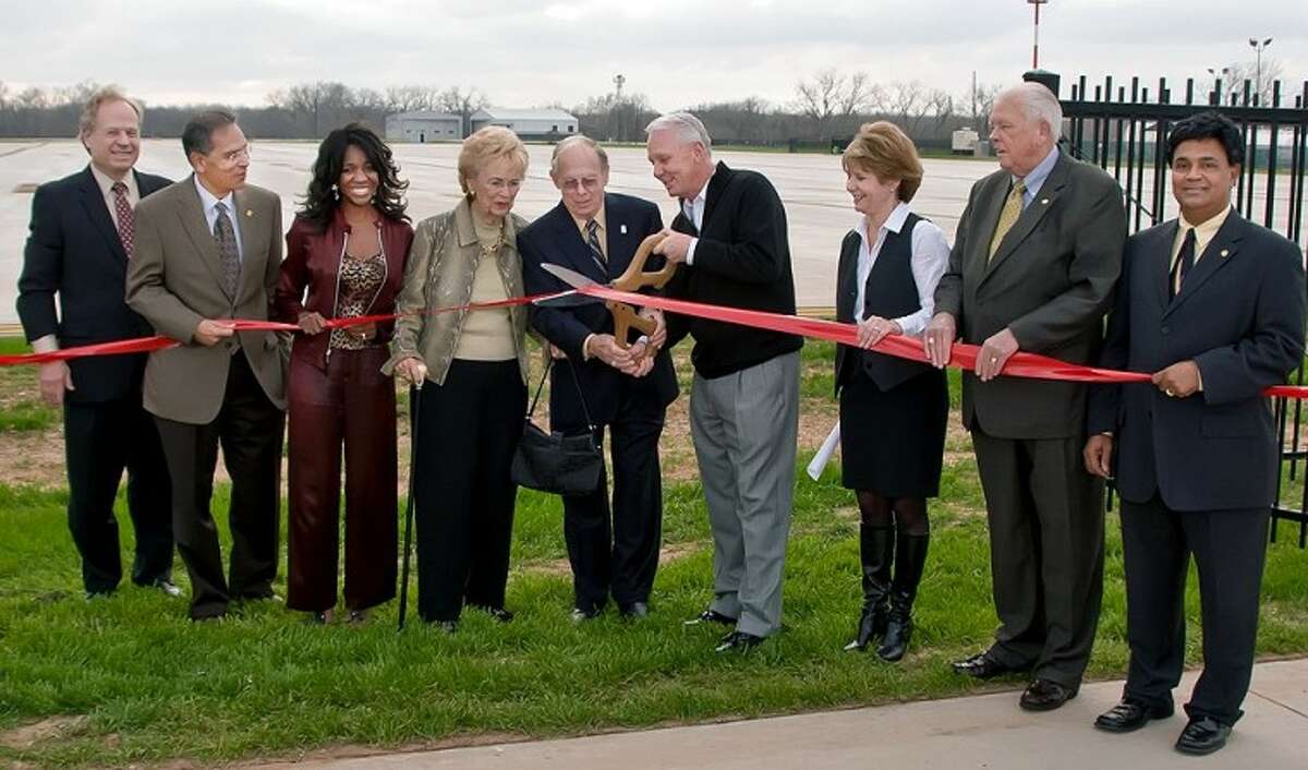 A ribbon cutting ceremony for Taxilane Juliett was held Jan. 19. Pictured from the left are City Manager Allen Bogard; Council member Harish Jajoo; Mayor Pro Tem Jacqueline Baly Chaumette; Peggy Duggan; former Mayor Lee Duggan; Mayor James A. Thompson; and Council members Bridget Yeung, Donald L. Smithers and Thomas Abraham.