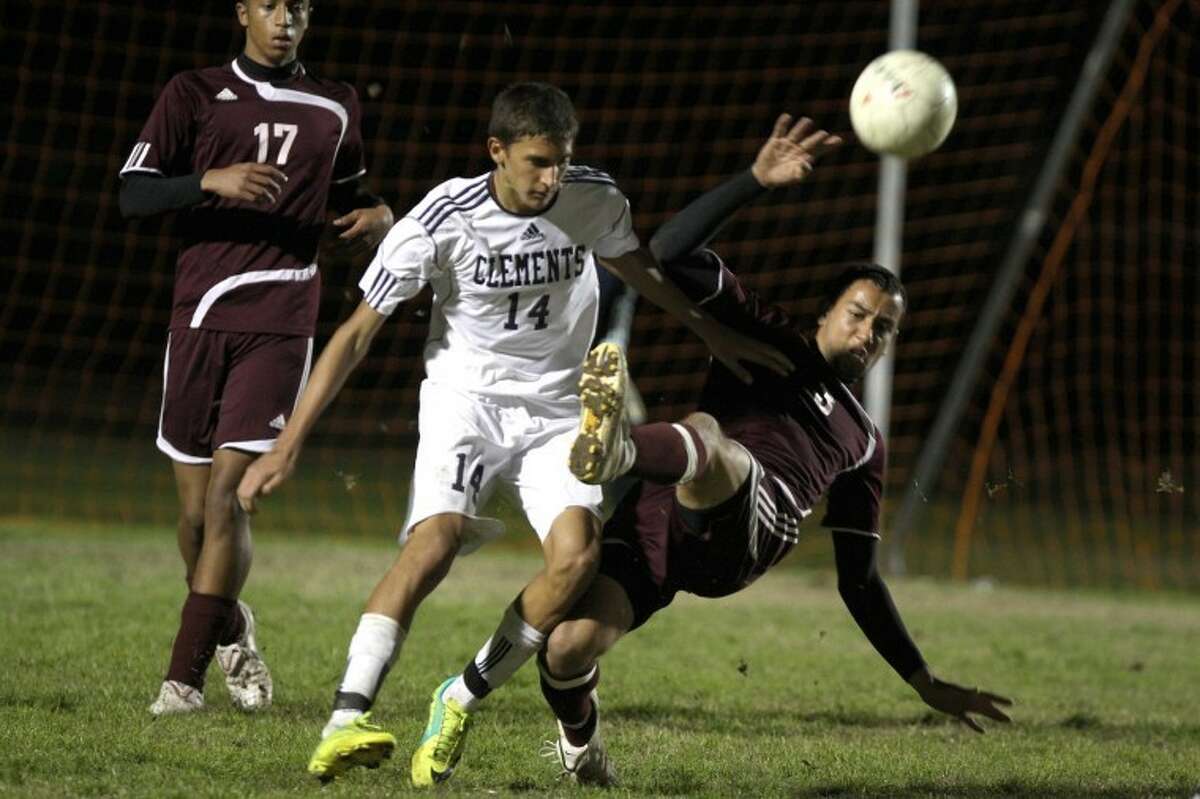 Clements' Kevin Matthews and Kempner's Hussein Naser fight for a ball during Clements' 4-3 victory Tuesday night. (Photo by Alan Warren)