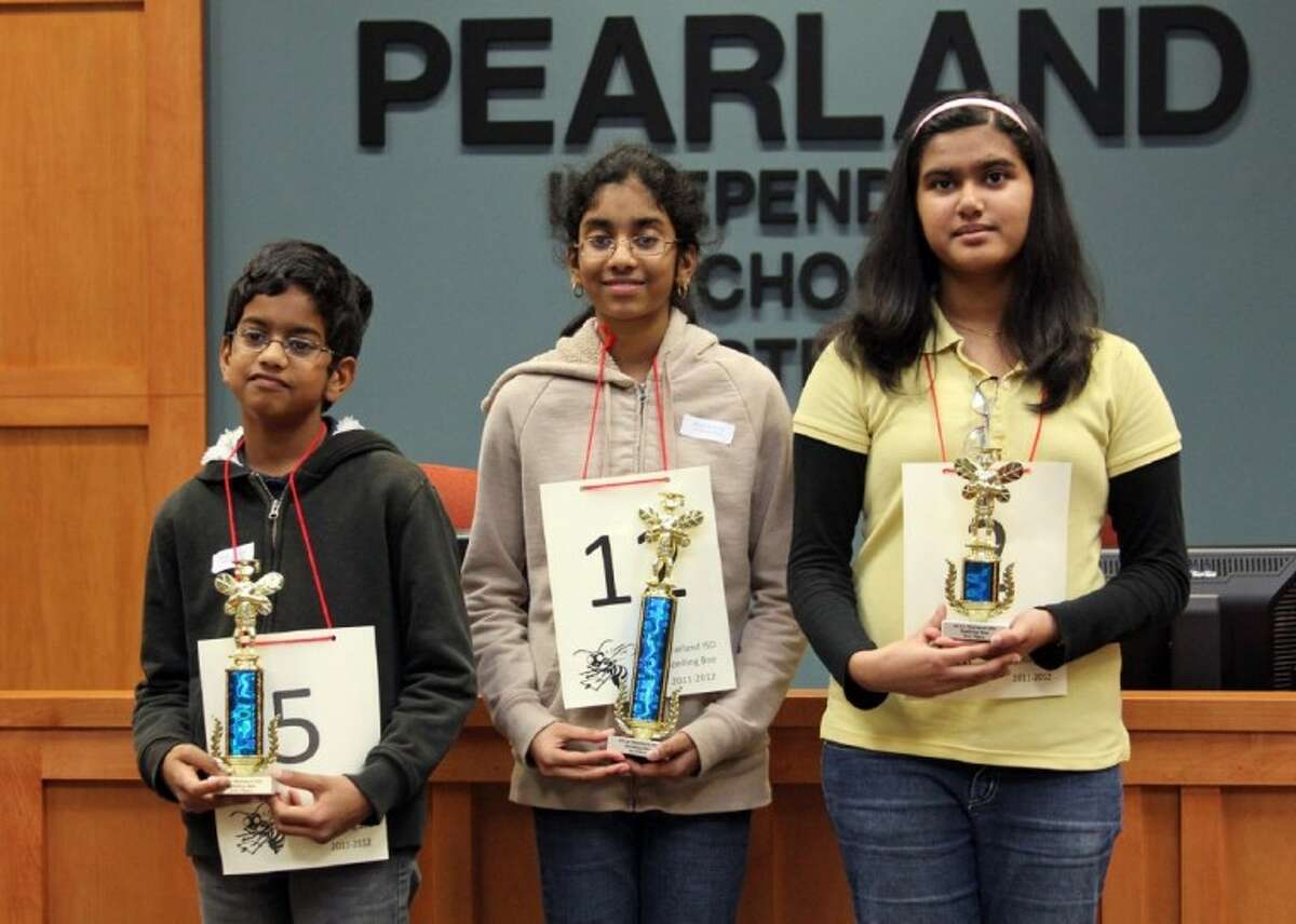 Winners of the Pearland ISD district Spelling Bee stand with their trophies Wednesday, Feb. 22. Left to right, Shourav Dasari won second place, Shobha Dasari won first place, and Maitreyi Nair won third place.