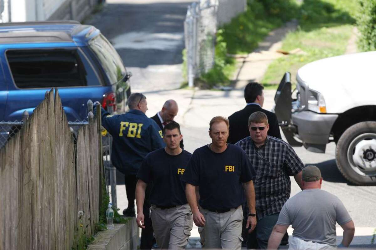 BRIDGEPORT, CT - MAY 4: FBI personnel conduct an evidence search of a house where Faisal Shahzad lived in connection with the botched Times Square bombing May 4, 2010 in Bridgeport, Connecticut. Shahzad, a suspect in this past weekend's failed car bomb plot in Times Square was taken into custody late Monday by FBI agents and New York Police Department detectives while trying to leave the country at John F. Kennedy Airport. (Photo by Daniel Barry/Getty Images)