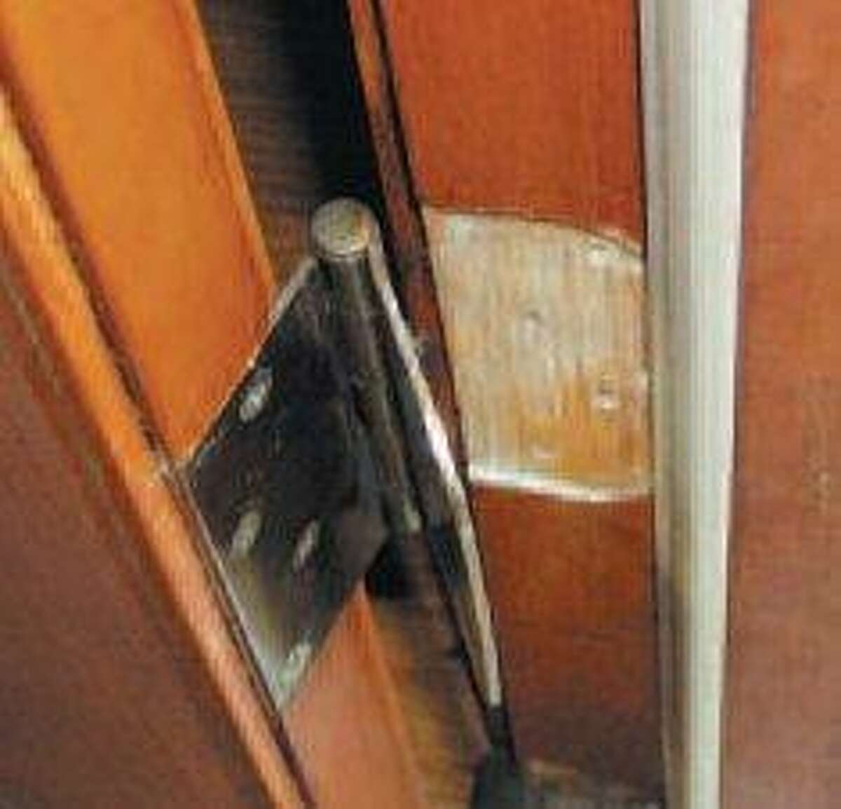 Washers behind a hinge help doors stay latched