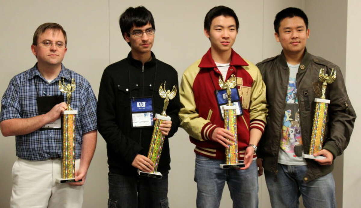 Cypress Woods High School computer science coach Ryan Hutt with the HP Code Wars 2013 winning team: Nikoli Sartagena (senior), Andrew Liu (junior) and Ben Lin (senior). To see more pictures from Saturday’s competition, visit www.yourhoustonnews.mycapture.com.