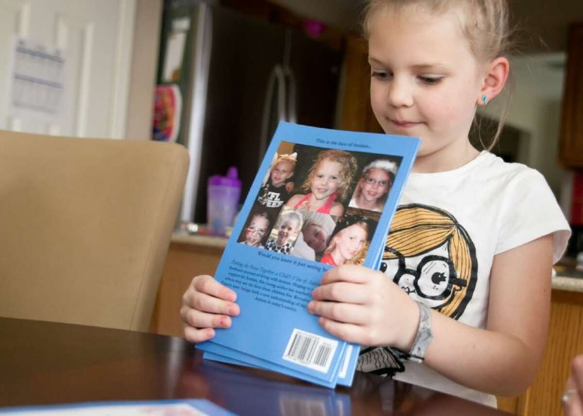 Seven-year-old Taryn Crain, of Kingwood, wrote about about her life with autism. The proceeds earned from the sale of her book will go toward the purchase of a service dog.