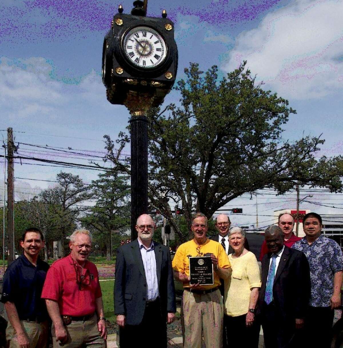 Rotarians gather to place commemorative plaque on Bellaire’s newest landmark - an old world clock tower in Paseo Park. Pictured L to R: Matt Lopez, Bellaire Assistant Chief of Police Byron Holloway, David Truran of Keller Williams Realty, club president Ed Seale, Tradition Bank CEO Craig Wooten, Judy Harwell, financial planner Surpris Cherazard, CPA Ralph Rieger, and Trung Doan, founder of StudioRed architects who designed the placement and orchestrated the installation.