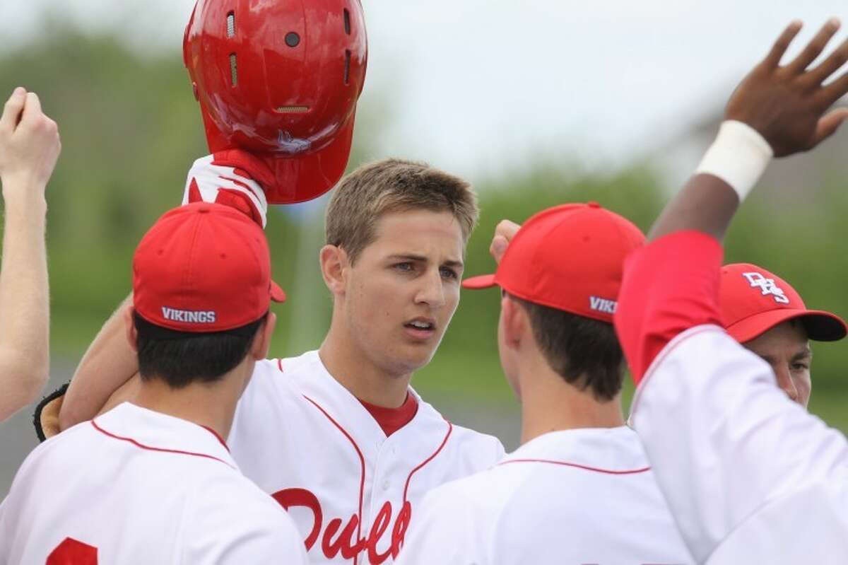 Dulles' Zach Belski gets congratulated on his home run against Elkins on Saturday. (Photo by Alan Warren)