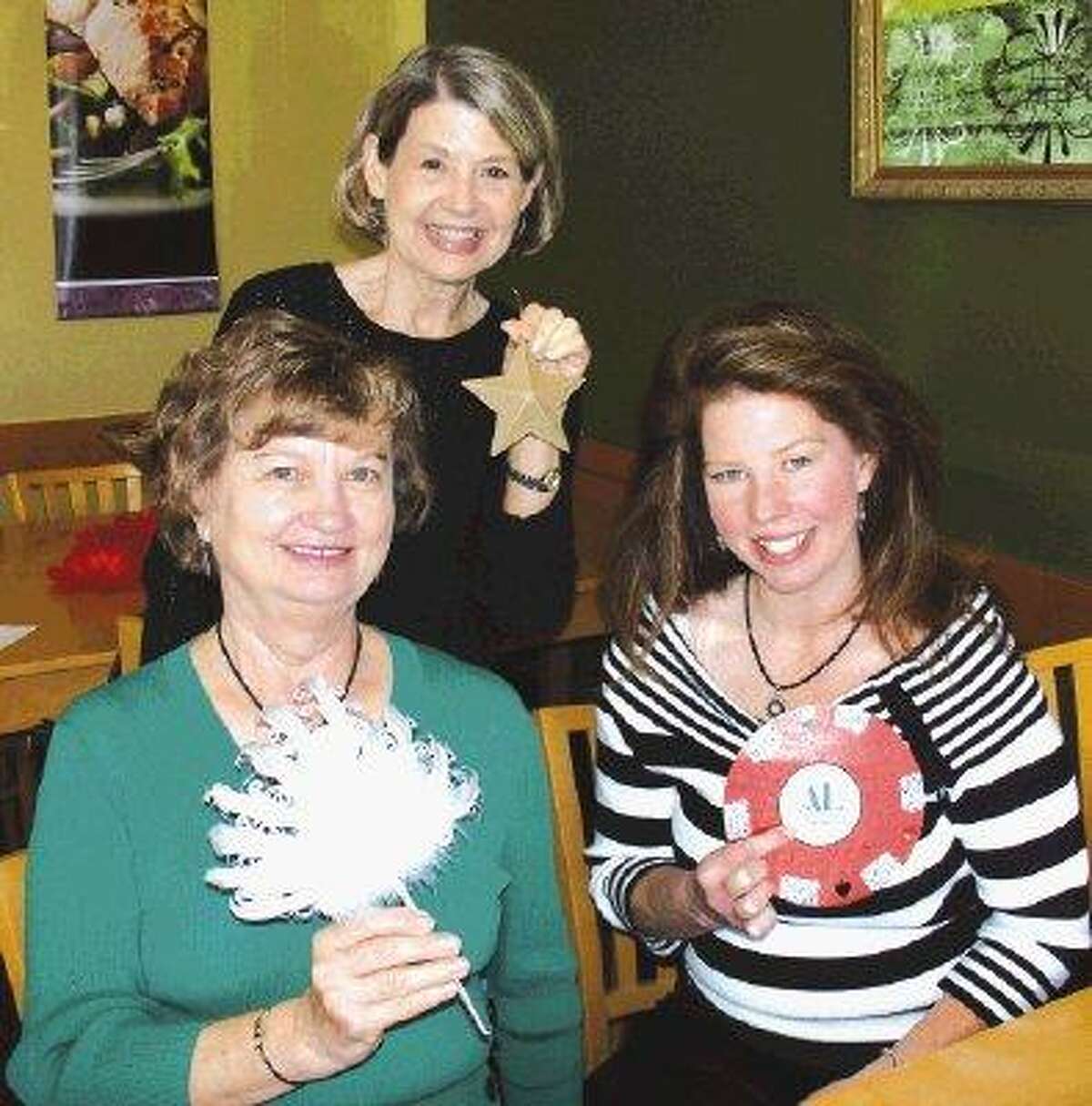 Georgia Piwonka, Patsy Horner and Amy Best work on bid paddles for the live auction at the Assistance League's big spring gala, coming up Saturday, April 10, in the South Shore Harbour Resort's Crystal Ballroom.