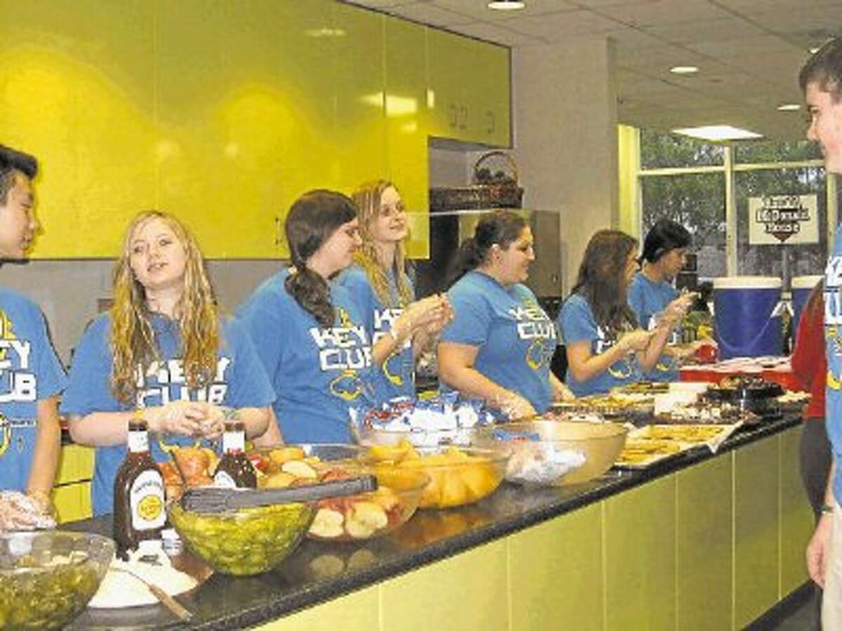 Members of the Cy Ranch Key Club, which is advised by the Kiwanis Club of Cy-Fair, serve food at the Ronald McDonald House at Houston’s Medical Center.