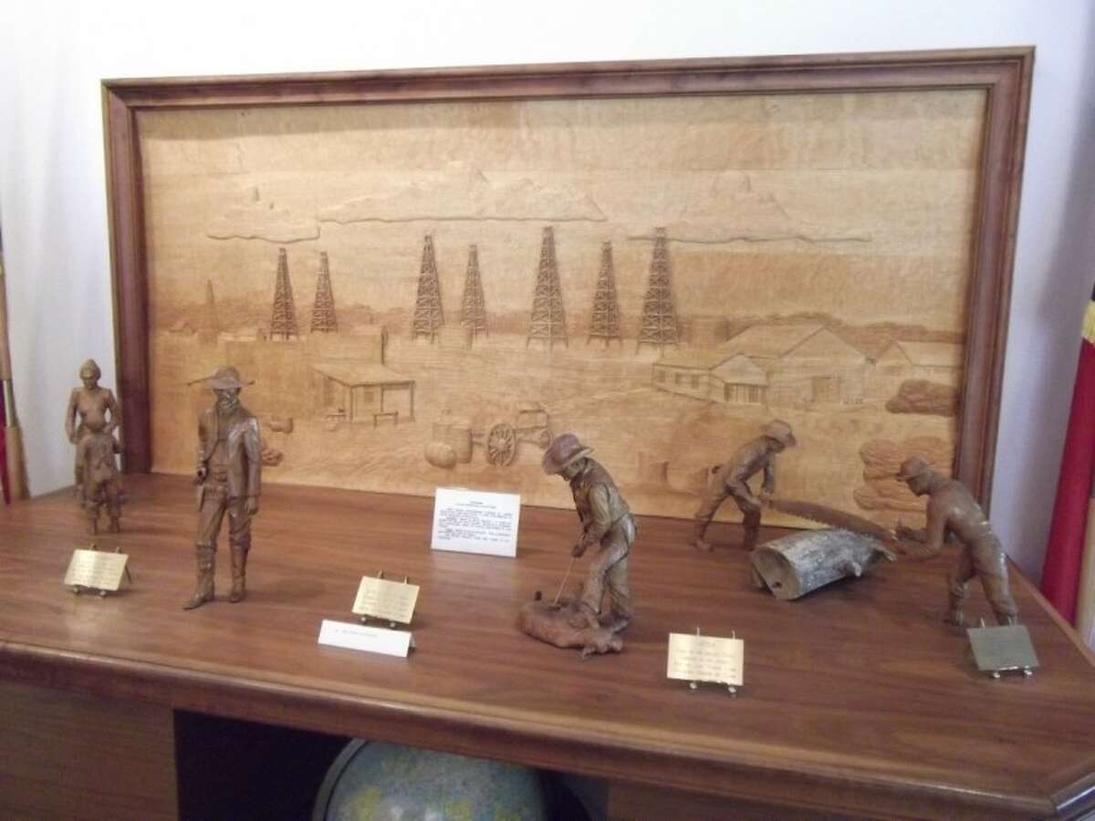 This deep relief diorama of the oil fields and wooden figurines were hand carved by former Humble resident Paula Devereaux. Each figurine took six weeks to make and is carved out of a single piece of wood.