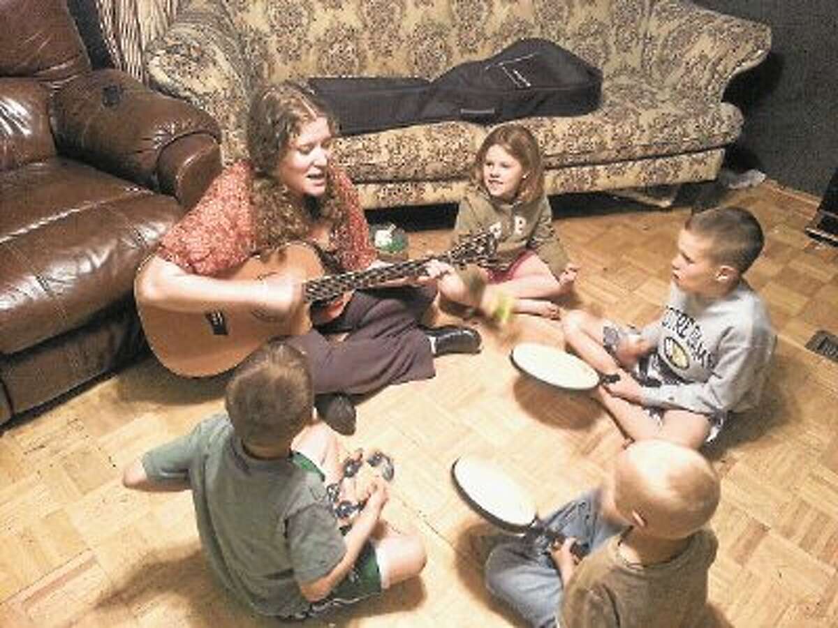 Amanda Bayless, a local music therapist, teaches local children with special needs to communicate more effectively with the use of music.