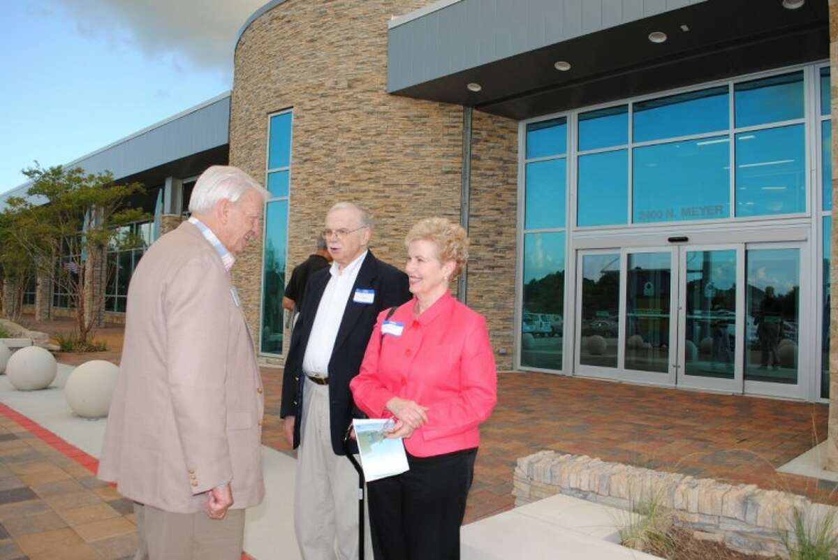 Evelyn Meador Library board member Jim Hargrove, left, thanks Lynn Meador Hall and her husband, Dan Edmundson, for attending the preview reception Friday night at the new library, which is named for her mother.