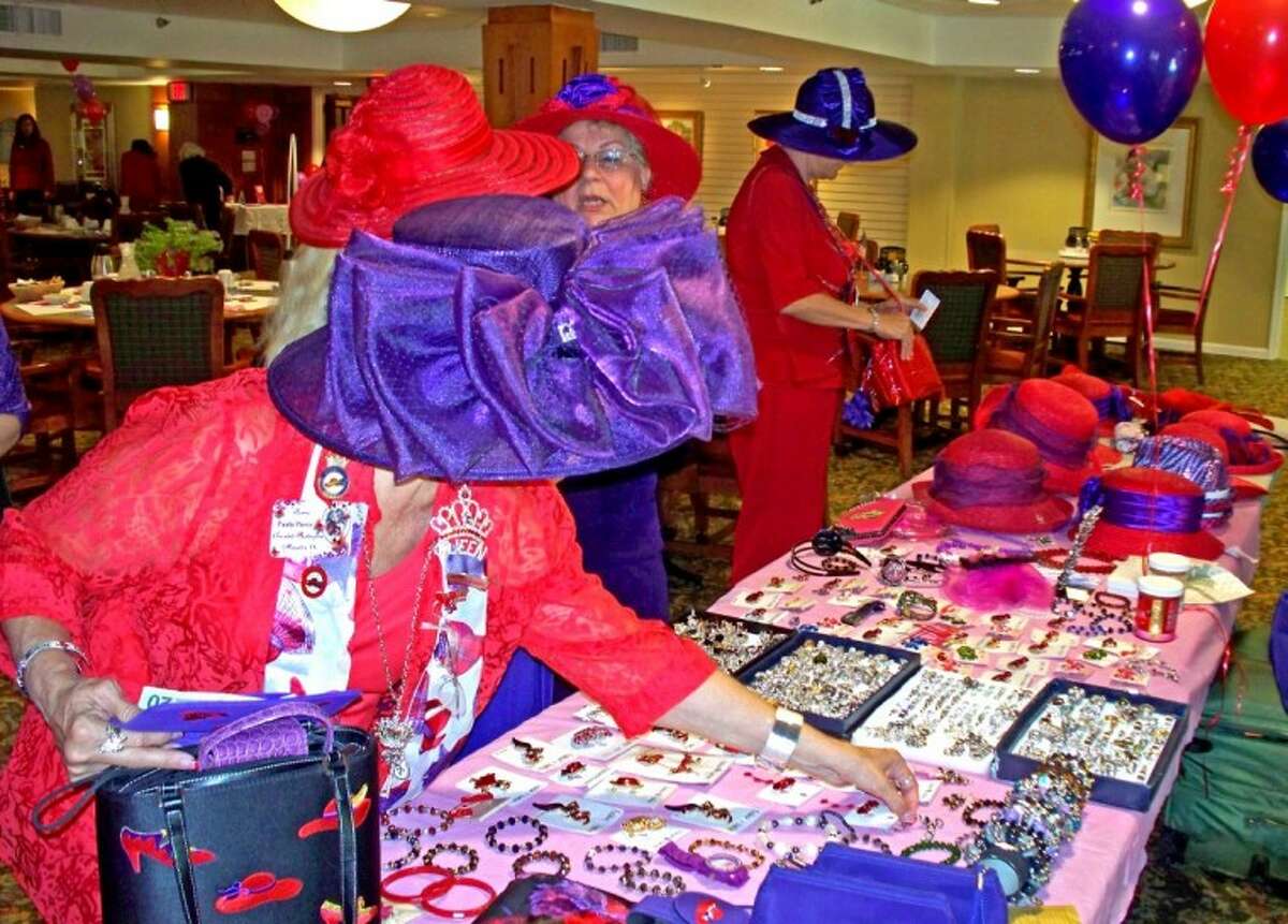 Red Hat Society members check out the vendors at their organization’s 14th anniversary celebration at the Terrace at Willowbrook.