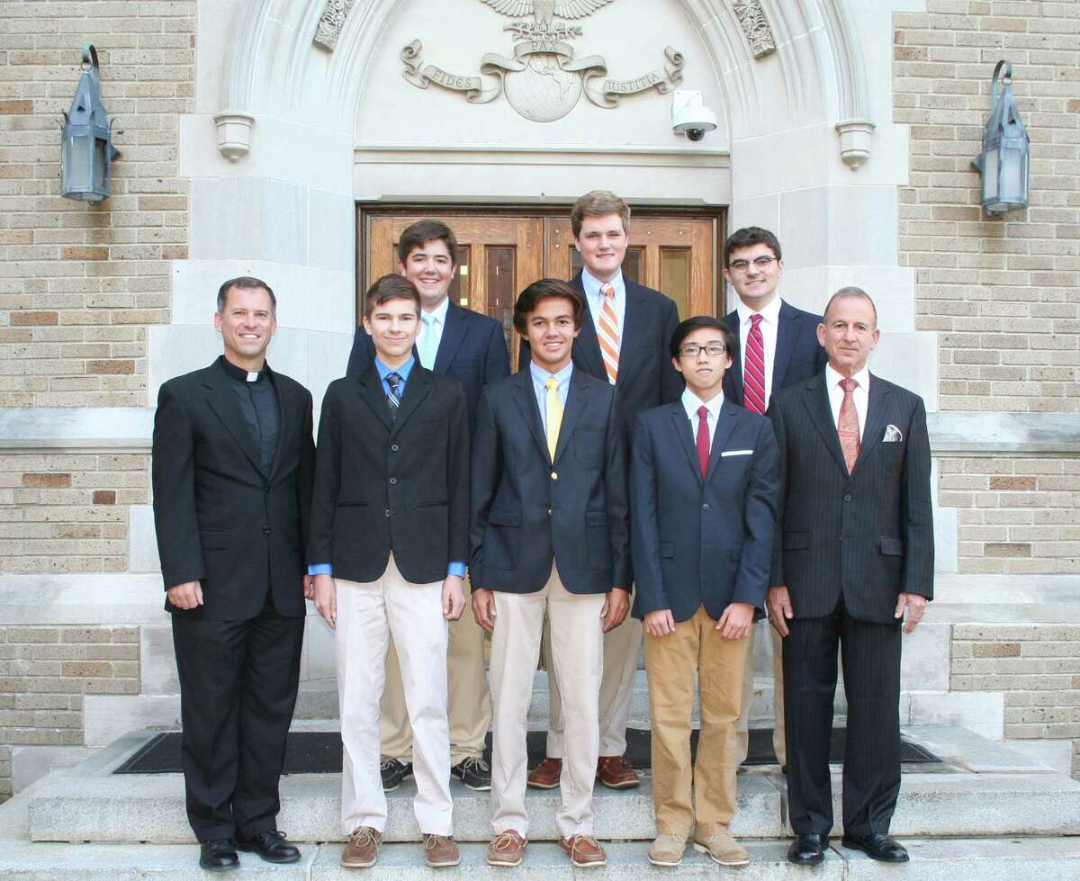 Fairfield College Preparatory School President Rev. Thomas Simisky (front left) stands with the school's National Merit Scholarship Program semifinalist Jonathan Siveyer, commended students Grant Ballesteros and Junlin Mo and school Principal Robert Perrotta. In the back row are commended students Brendan Flynn (left), Tom Paul and Ben Martinez. The seniors at the Fairfield, Conn. school received their honors this fall.