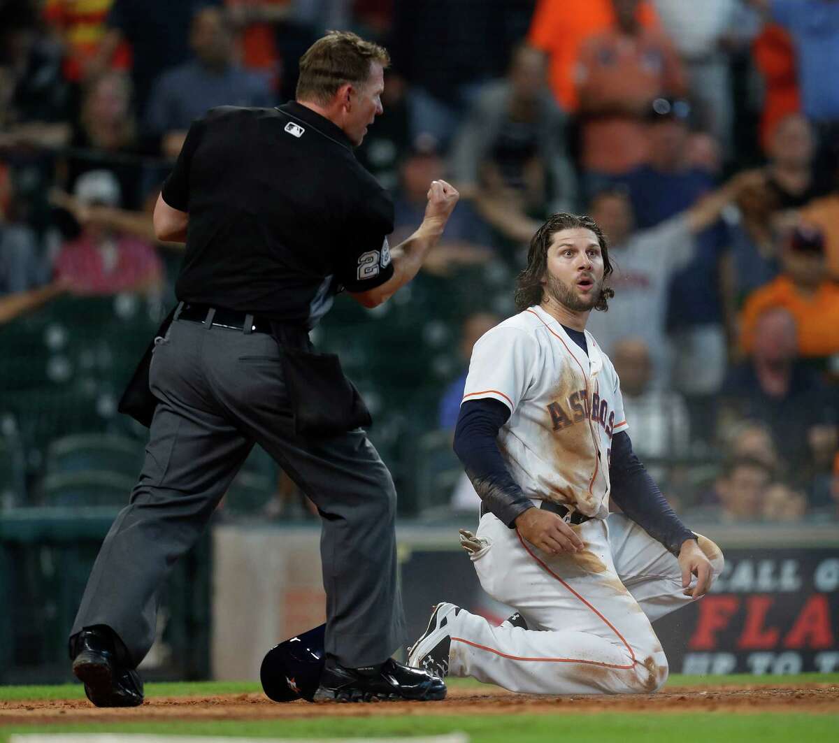 Home plate umpire Jim Wolf calls Houston Astros Jake Marisnick (6) out at home on a play later challenged and overturned during the fifth inning of an MLB game at Minute Maid Park, Wednesday, Sept. 28, 2016 in Houston.
