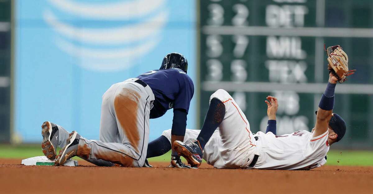 Houston Astros shortstop Carlos Correa (1) lies on his back after tagging Seattle Mariners Guillermo Heredia (5) out at second base during the eighth inning of an MLB game at Minute Maid Park, Wednesday, Sept. 28, 2016 in Houston.