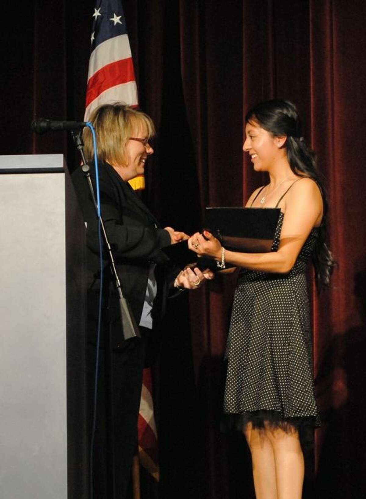 ACC Foundation Executive Director Wendy Del Bello, left, hands a scholarship award to Alvin High School student Miriam Higuera during Award Night at the school in 2013.