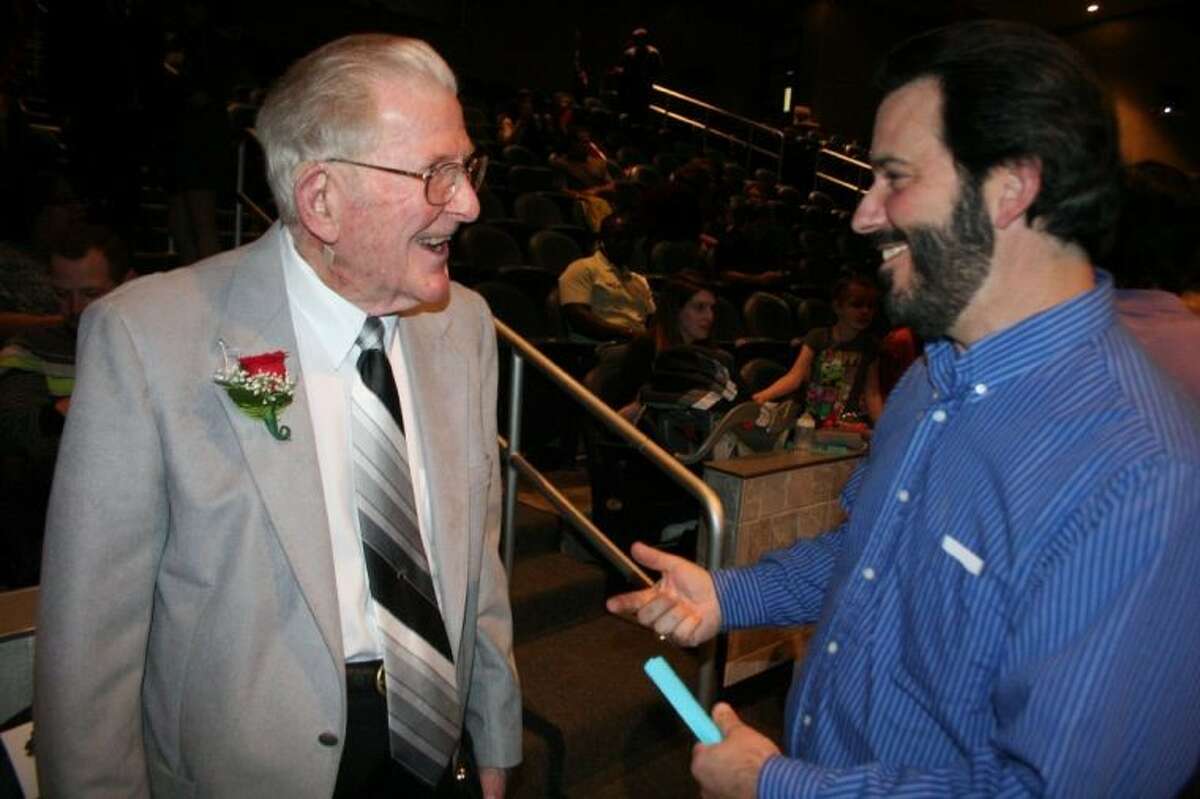 Doug Love, left, visits with a fellow teacher at last year’s Just About Kids “For the Love of Music” event. Love died at the age of 90 May 2013 after complications from surgery. The event was named in honor of him.
