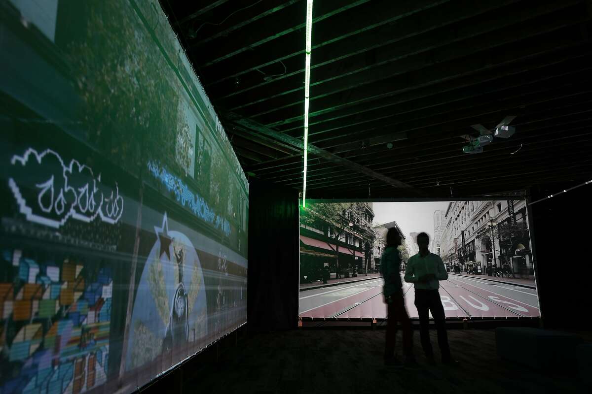 Artists Stefano Corazza and Gearge Zisiadis against their conception of what the installation will look like when completed, using video screens of Market St. and streaking colored lights moving along the roadway, seen in San Francisco, California on Wed. Sept. 28, 2016. The people who brought us the Bay Lights on the Bay Bridge intend to run lights up and down Market St.,