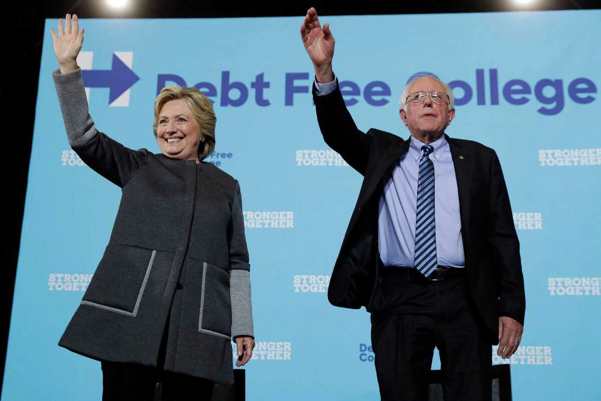 Democratic presidential candidate Hillary Clinton and Sen. Bernie Sanders, I-Vt. acknowledge the audience at a campaign stop at the University Of New Hampshire in Durham, N.H., Wednesday, Sept. 28, 2016. (AP Photo/Matt Rourke)