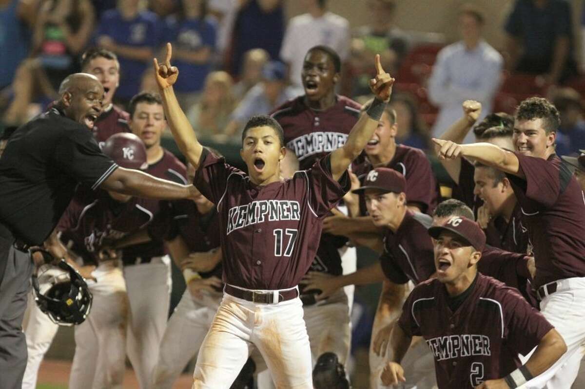 Kempner players wait for Dominic Taccolini to touch home plate after hitting a grand slam to win the game and series with Cy Creek in the bottom of the 13th inning at University of Houston's Cougar Field. (Photo by Alan Warren)