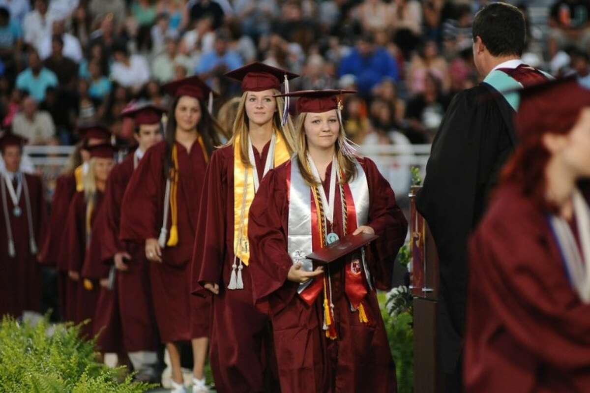 Michelle Harris walks across the sage to receive her diploma during the Clear Creek High School graduation ceremony Thursday, May 31.