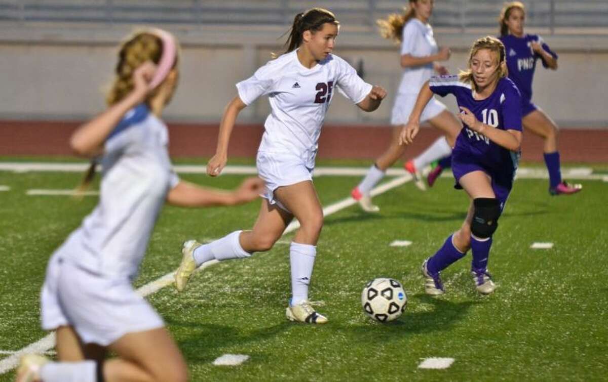 Magnolia’s Allison Abendschein leads an attack downfield during the first half of a Region III-4A sectional playoff match against Port Neches-Groves on Friday at Turner Stadium in Humble.