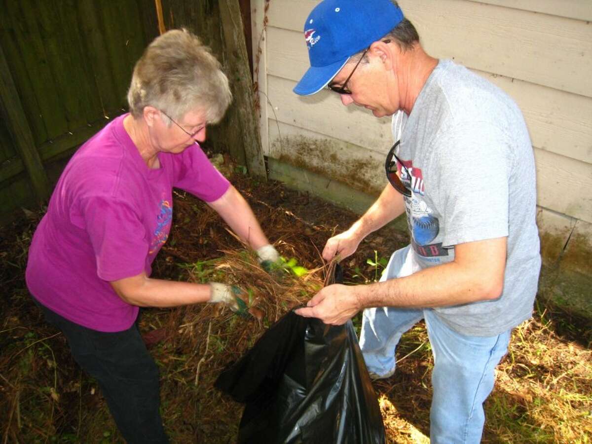 Volunteer teams meet to help neighbor clean up her home