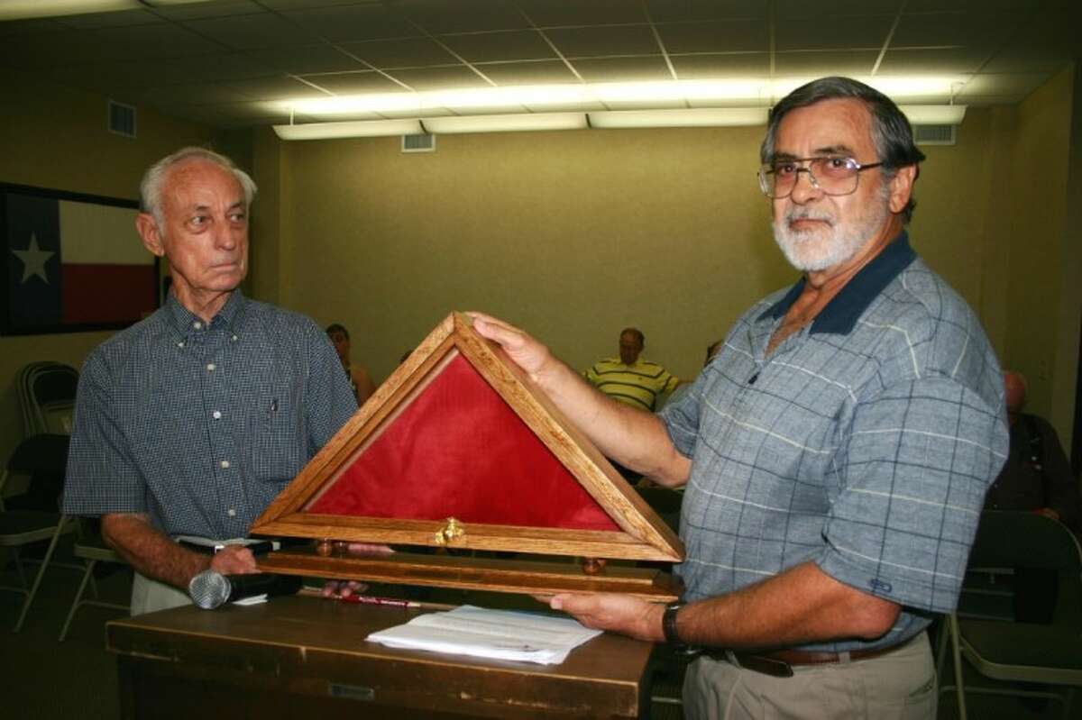 Dayton resident Bill Fox, left, and former Dayton Mayor Steve Stephens at the July 2 Dayton City Council meeting hold the flag display case hand-made by Fox that would hold a U.S. Flag flown over Dayton. Stephens would deliver it to the family of Marine Sgt. Wade Daniel Wilson, who died May 11 while fighting in Afghanistan. Stephens knew Wilson since he was a teenager. U.S. Rep. Ted Poe, at Stephens' request, paid tribute to Wilson on the floor of the U.S. House of Representatives on June 1. Dayton City Council, which also honored the fallen Marine by resolution, permitted the flag to be flown over Dayton on the Fourth of July, as City Manager David Douglas recommended.